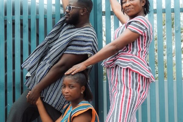Elegant group wearing vibrant African fugu outfits, beautifully posing in Accra, Ghana.